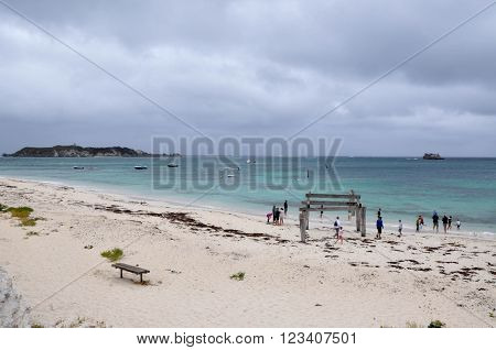 HAMELIN BAY,WA,AUSTRALIA-JANUARY 17,2016: People and jetty ruins on the turquoise Indian Ocean coast line on a rainy day in Hamelin Bay, Western Australia.