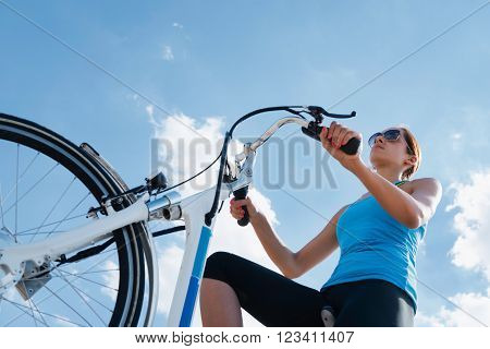 Riding electric bicycle or e-bike shot against blue sky convenient copy space