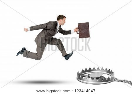 Running businessman with bear trap isolated oon white background