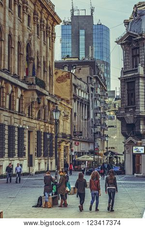 Bucharest Romania - October 6 2013: People socialize and enjoy a walk on the cobblestone streets of the historic center Lipscani the Bucharest's liveliest entertainment district.