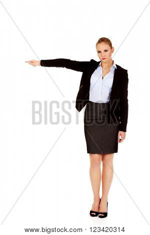 Angry business woman shows get out gesture