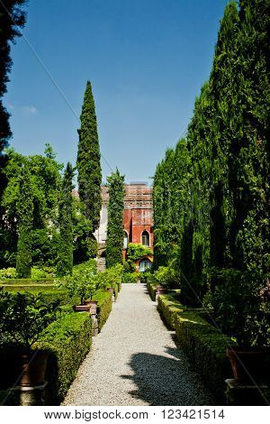 Wonderful green garden with cypresses in Verona, Italy