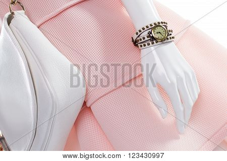 Purse and watch on mannequin. Female mannequin with stylish watch. White leather purse and watch. Classic watch and leather handbag.