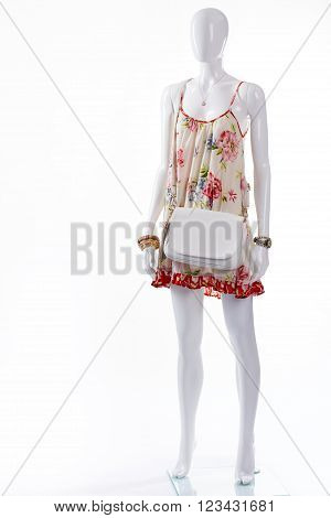 Sarafan with accessories on mannequin. Female mannequin wearing summer outfit. Different accessories and sarafan. Lady's summer outfit with handbag.