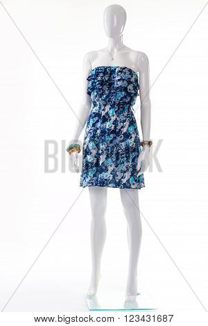 Blue dress on white mannequin. Female mannequin in vintage dress. Strapless retro dress and accessories. Young lady's classy summer outfit.