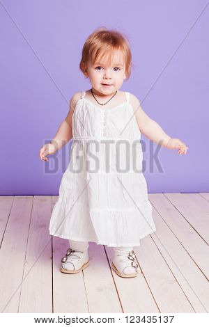 little girl in a white Sarafan in studio