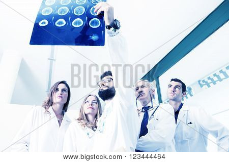 group of doctors examining an x-ray in hospital