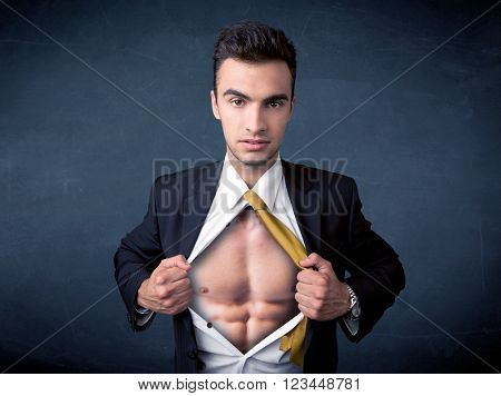 Businessman tearing off his shirt and showing mucular body concept on background