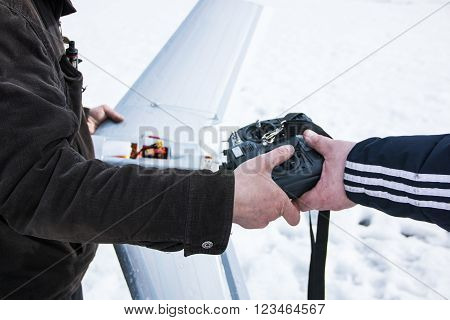 Remote Control For Quadrocopter Unmanned Aerial Vehicle In Snow In Their Hands.