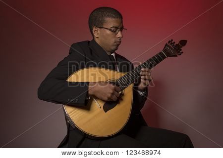 fado musician with a portuguese guitar, studio