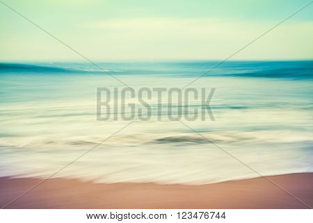 An abstract ocean seascape with blurred panning motion. Image displays a retro vintage look with cross-processed colors.