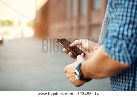 Close up of a man using mobile smart phone