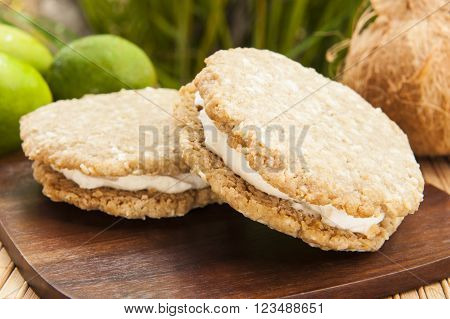 Vegan oatmeal cookie ice cream sandwich with coconut lime ice cream outdoors