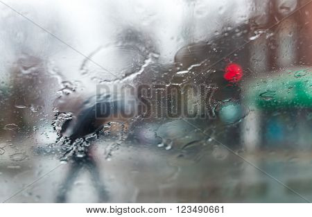 Blurred picture of traffic through a car windscreen during heavy rain.