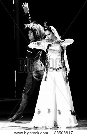 BAKU, AZERBAIJAN - JANUARY 18 2014 
Traditional Azerbaijani wedding dance: man and woman. A dancer in a white dress carries a symbolic dish of rice to the newly married couple at a wedding reception in Azerbaijan
