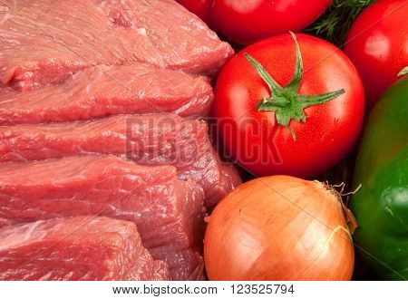 fresh raw beef with vegetables closeup, top view