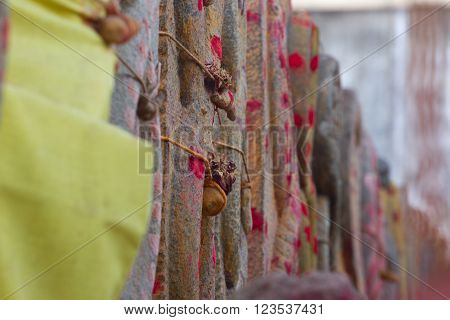 Group of yellow tombs with red dots in Shiva temple Kanchipuram Tamil Nadu