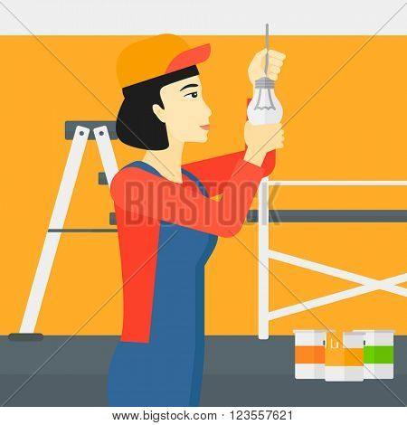 Electrician twisting light bulb.
