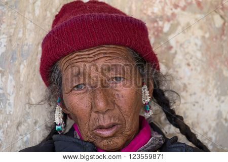 LAMAYURU, INDIA - JUNE 15, 2015: Unidentified buddhist old women during mystical mask dancing Tsam mystery dance in time of Yuru Kabgyat Buddhist festival at Lamayuru Gompa, Ladakh, North India