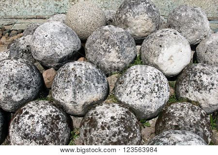 Old cannonballs, a core of ancient tools. Historical sites fortress Velikiy Novgorod, Russia. Stone cannon. Rare weapons of the Slavic wars.