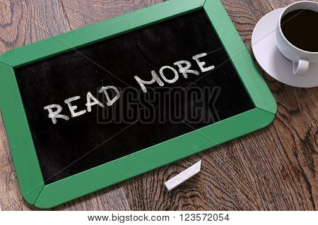 Hand Drawn Read More Concept  on Small Green Chalkboard. Business Background. Top View. 3D Render.