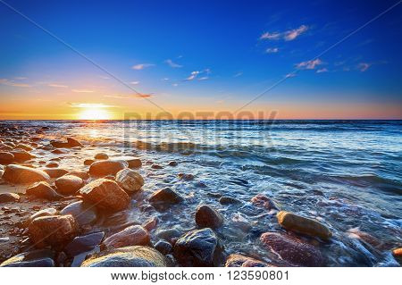 Sunset over the Baltic sea. The pebbly beach in Rozewie. HDR - high dynamic range