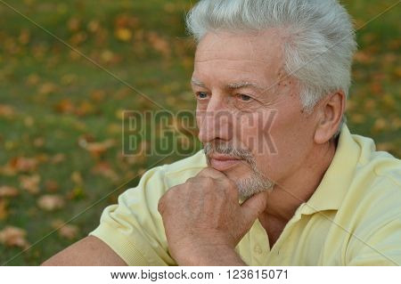 portrait of thoughtful senior man  in  park