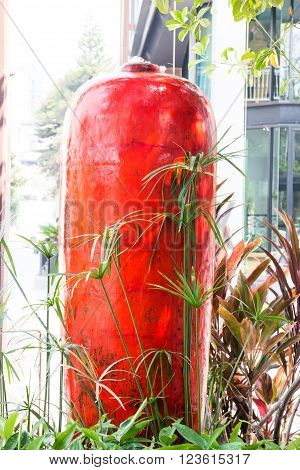 Jar of water springing in garden stock photo