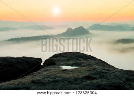 Dreamy Misty Landscape. Majestic Mountain Cut The Lighting Mist. Deep Valley Is Full Of Colorful Fog