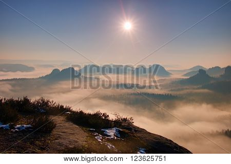 Dreamy Misty Landscape. Majestic Mountain Cut The Lighting Mist. Deep Valley Is Full Of Colorful Fog