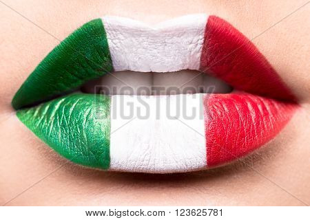 Female lips close up with a picture flag of Italy. Green, white, red