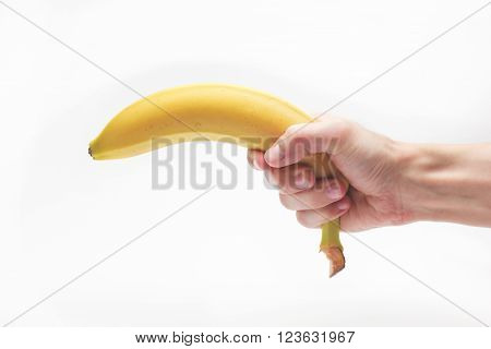 Banana fruit gun hold in caucasian white male hand over white background.
** Note: Visible grain at 100%, best at smaller sizes