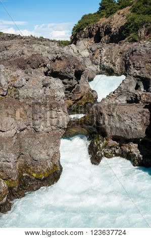 Barnafoss is a dangerous Icelandic waterfall in the west of the island. It is formed by Hvita river going through a narrow canyon. 