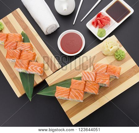 Japanese cuisine. Sushi with fresh ingredients over black background.