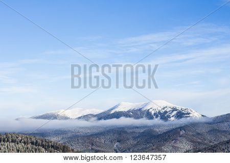 Snow capped mountain against the blue sky