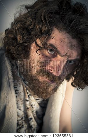 Silly realistic caveman with dirty face in portrait
