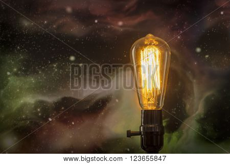 Decorative antique style filament light bulb with starscape background