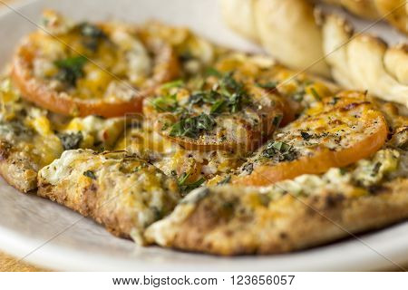 Personal size flatbread authentic margherita pizza with fresh tomatoes
** Note: Shallow depth of field