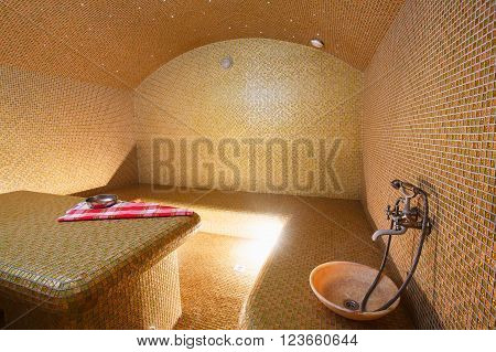 Interior of Turkish sauna, classic Turkish hammam at spa center. Spa, relaxation and resort health care center interior. Decorated in golden colors. Eastern hammam.