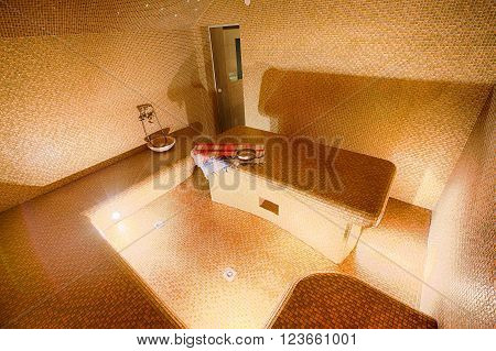 Interior of Turkish sauna, classic Turkish hammam at spa center. Spa, relaxation and resort health care center interior. Decorated in golden colors. Eastern hammam.