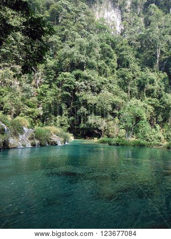 A beautiful azure colored pool next to a steep forested mountain in Semuc Champey Guatemala.
** Note: Visible grain at 100%, best at smaller sizes
