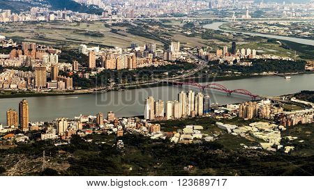 Scenery of Tamsui river with famous Guandu Bridge far away in Tamsui, New Taipei City, Taiwan