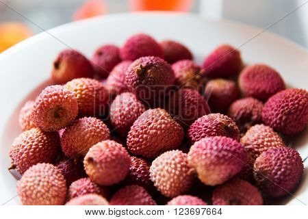 food, fruits and eating concept - lychee on plate