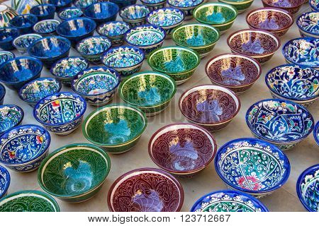 Rows of cups with traditional uzbekistan ornament on a street market of Bukhara Uzbekistan Central Asia. Silk Road