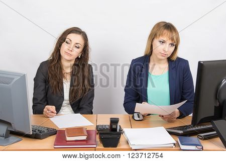 Employees Of The Office Sitting At A Desk With A View Of The Downtrodden