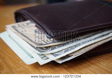 Detail of the American money (USD, US, US dollars), bank notes inserted in the leather wallet