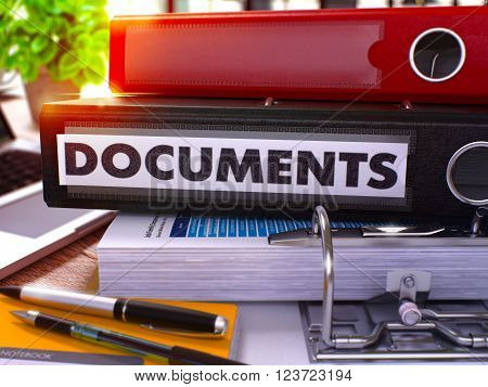 Black Office Folder with Inscription Documents on Office Desktop with Office Supplies and Modern Laptop. Documents Business Concept on Blurred Background. Documents - Toned Image. 3D.