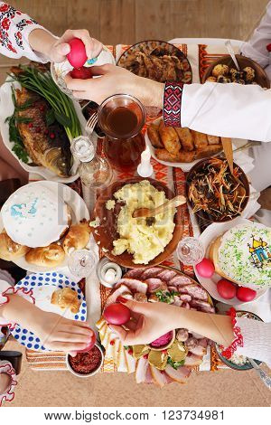 Slavic family at the festive Easter table with snacks