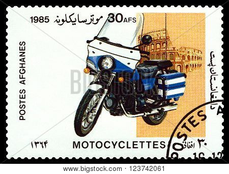 STAVROPOL RUSSIA - MARCH 30 2016: a stamp printed in Afghanistan shows an motorcycle against the backdrop of the Coliseum stamp devoted to the centenary of the invention of motorcycle cirka 1985