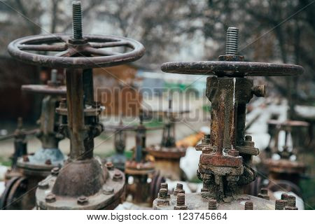 old rusty industrial tap water pipe and valve